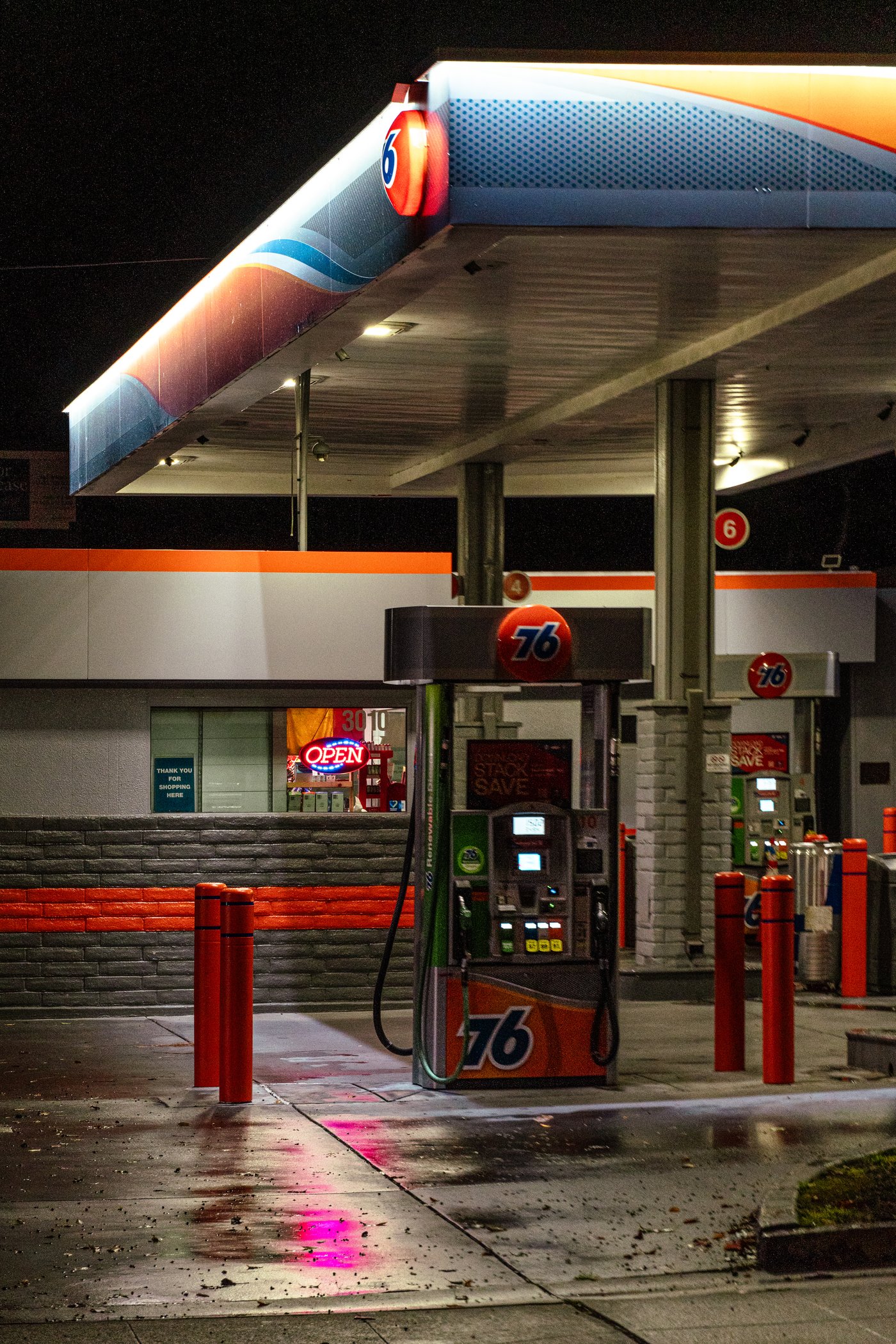 A gas station forecourt lit at night for a commercial client
